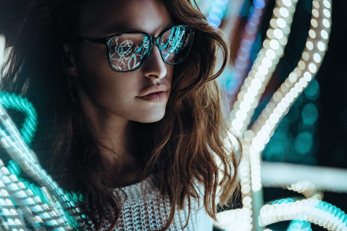 Woman with glasses reflecting lights