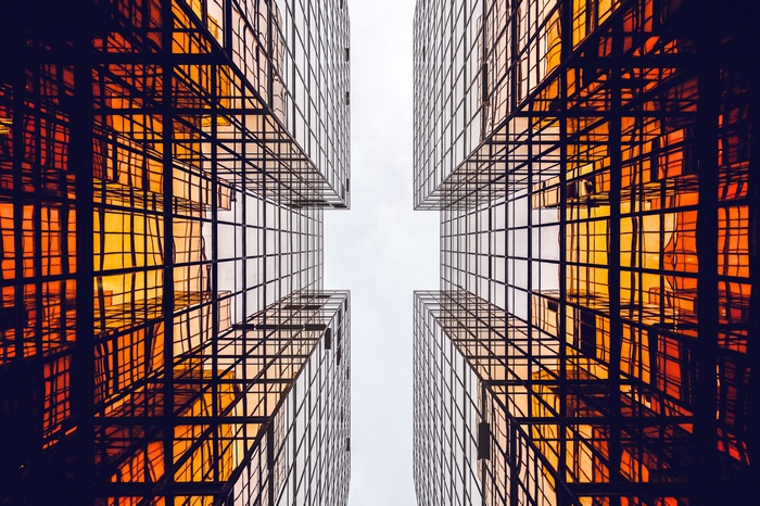 Looking up at modern glass buildings