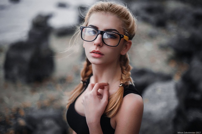 Woman with blonde pigtails and glasses