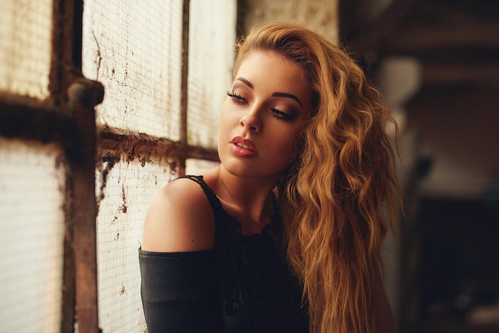 Woman with blonde hair by a window