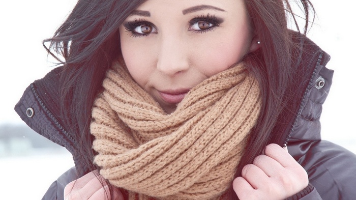 Woman with black hair and brown eyes wearing a scarf and jacket