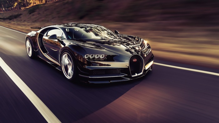 Black Bugatti Chiron driving on a road with motion blur