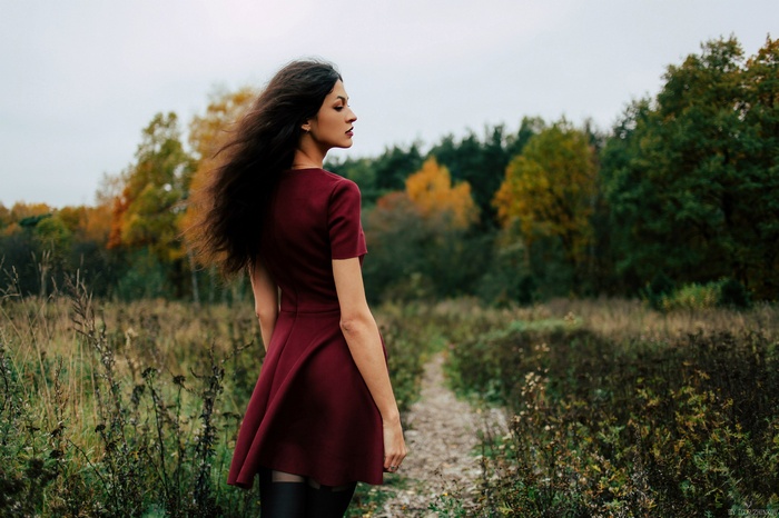 Woman in red dress in autumn field