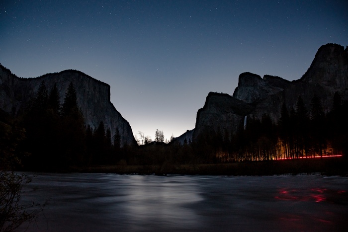 Night landscape with mountains, forest, and river