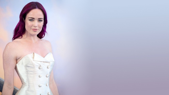 Caity Lotz in a white dress