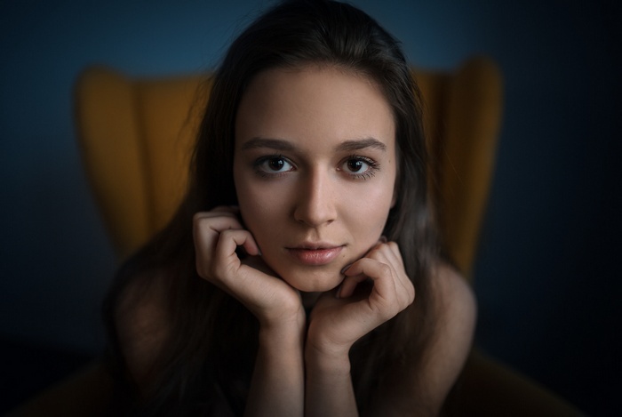 Woman sitting in a yellow chair