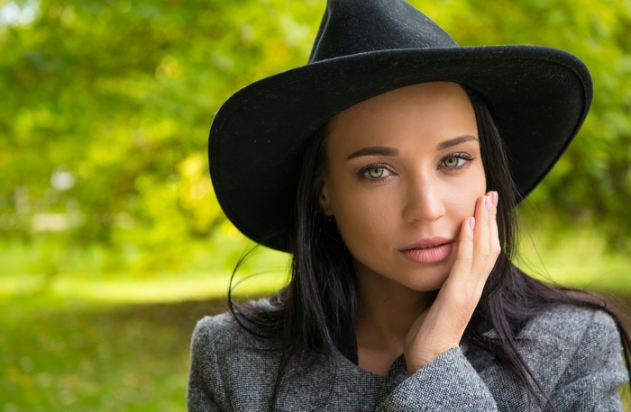Woman in black hat and grey coat