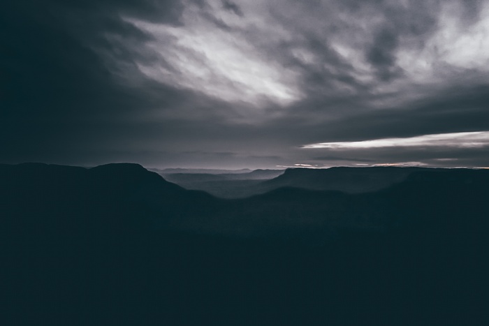 Dark mountain landscape with cloudy sky