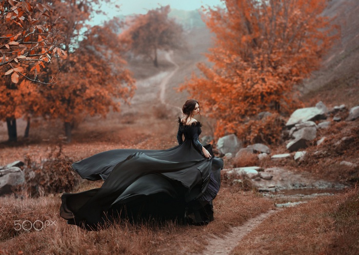 Woman in black dress in fall nature