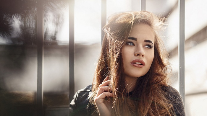 Woman with long brown hair and blue eyes