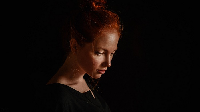 Portrait of a redhead woman with her hair in a bun