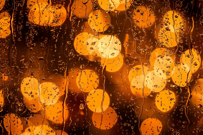 Raindrops on glass with bokeh lights