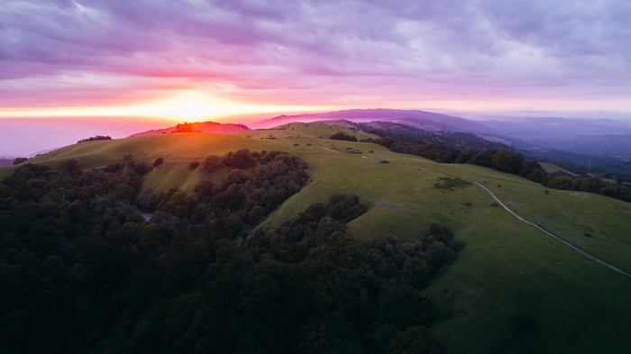 Sunset over rolling hills and forests near Redwood City