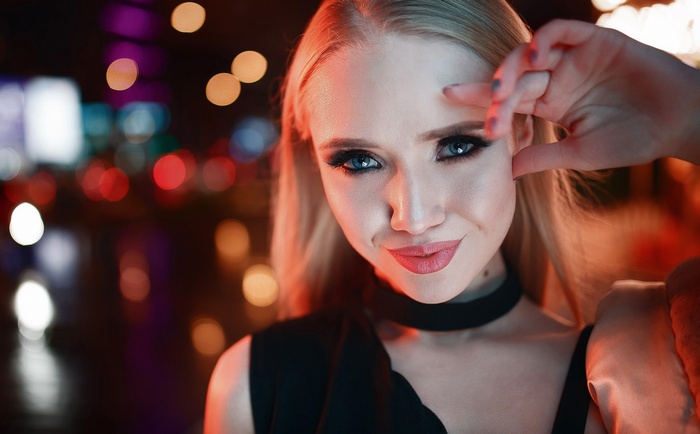 Woman with blue eyes and blonde hair at night