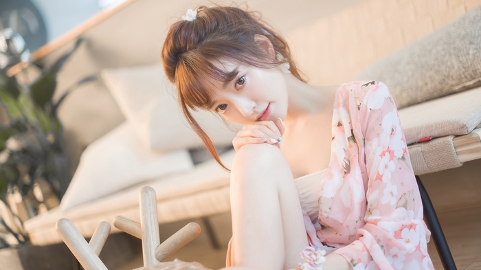 Asian woman in floral robe indoors