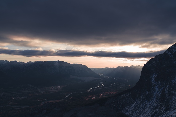 Sunrise over Ha Ling Peak valley with dramatic clouds