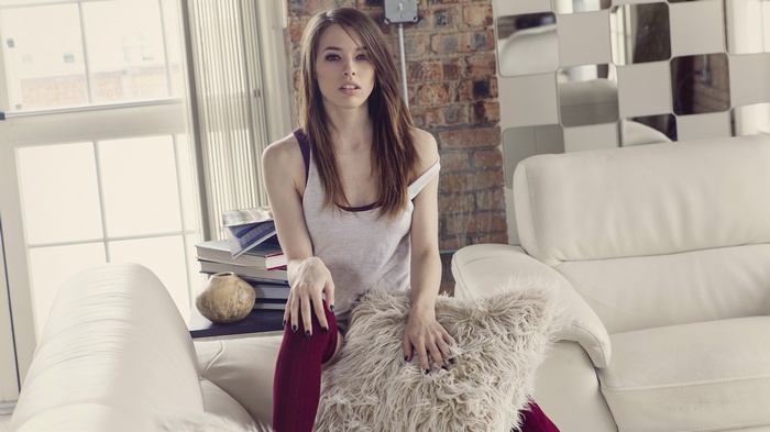 Caitlin McSwain sitting on a couch indoors