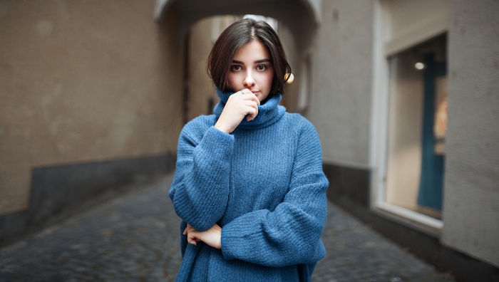 Woman in blue turtleneck sweater outdoors