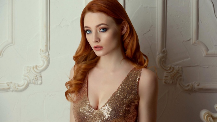 Redhead woman in sequined dress with blue eyes