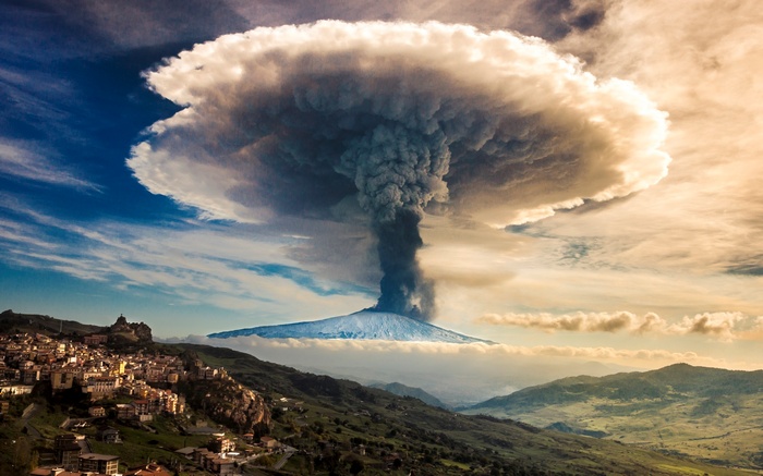 Volcano eruption over a town