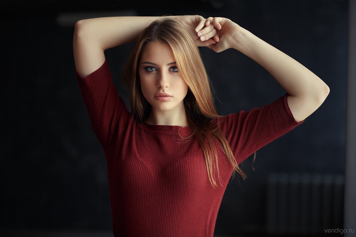 Woman with long blonde hair in red shirt