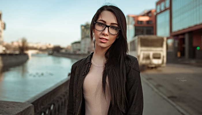 Woman with glasses by a river