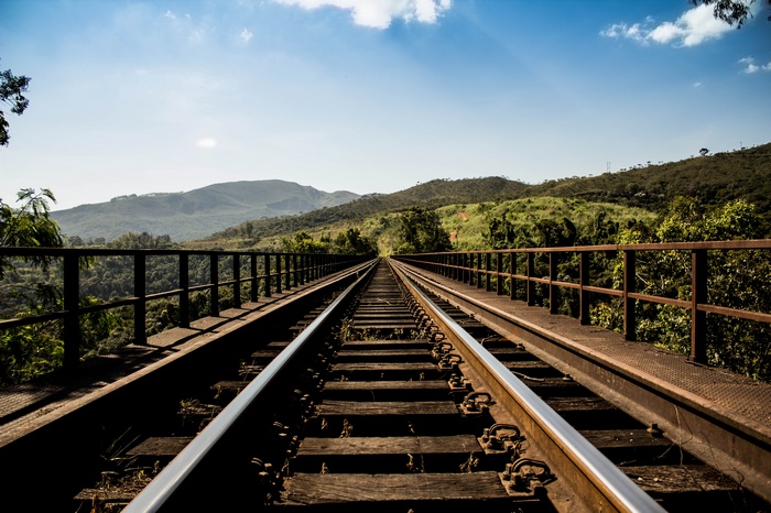 Railway bridge over a valley with mountains