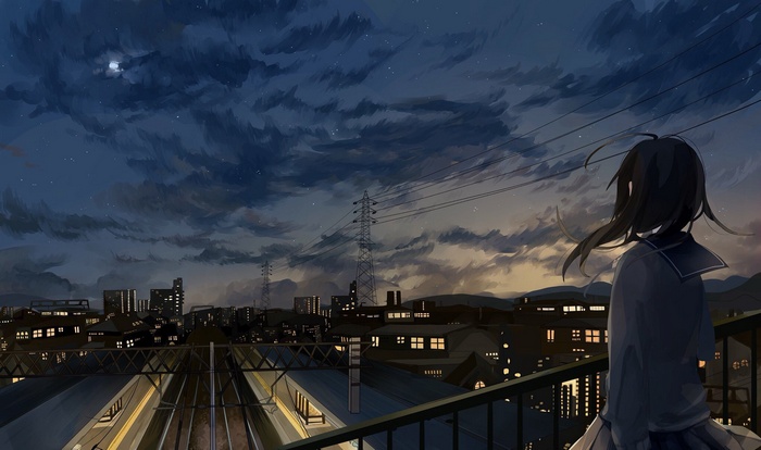Girl in school uniform looking at city at night