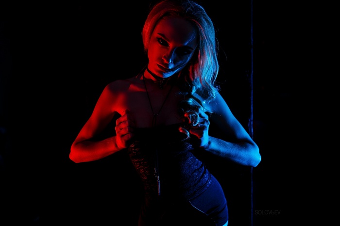 Woman with blonde hair in a black outfit