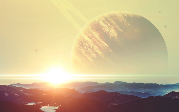 Planet with rings over mountains at sunrise