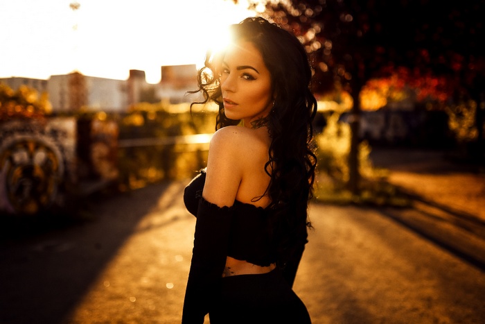 Woman posing outdoors during sunset