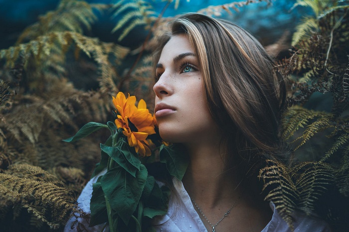 Woman with sunflower and ferns