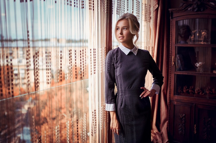 Woman in a dress by the window