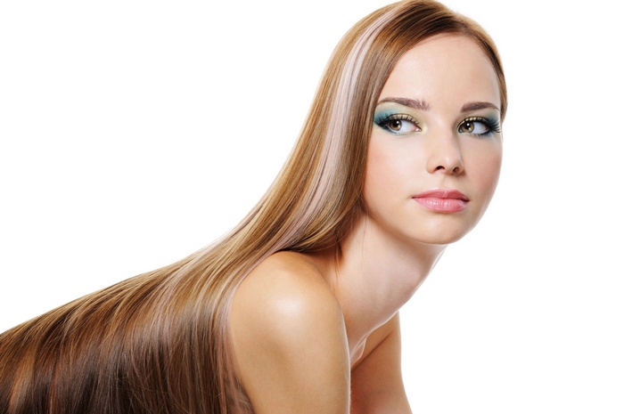 Woman with long blonde and brown hair and makeup