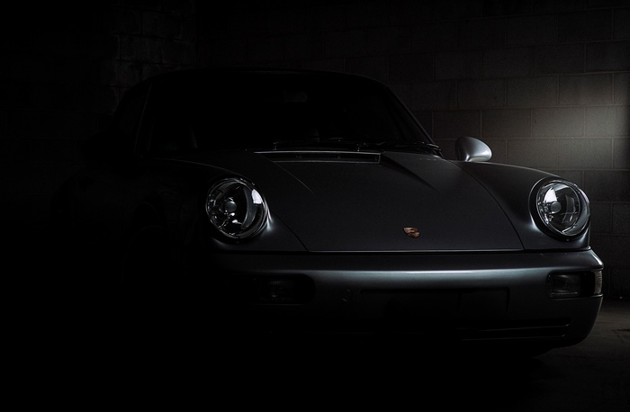 Porsche 911 Carrera in a dark garage