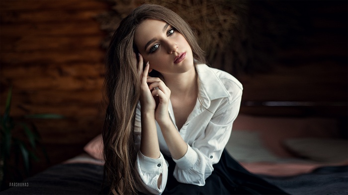 Woman with long brown hair and green eyes