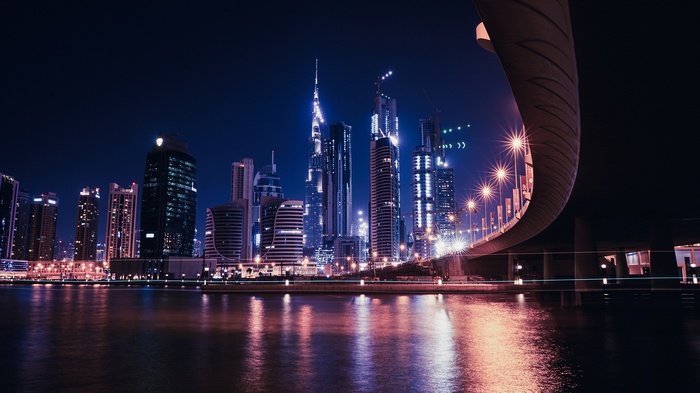 Dubai skyline at night with a bridge