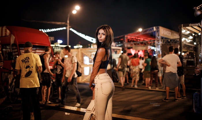 Woman in jeans at an outdoor night event