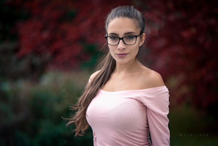 Pavlina with glasses and long hair outdoors
