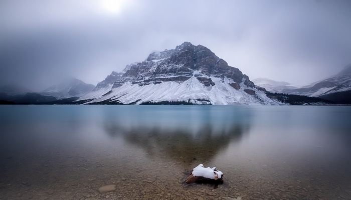 Snow-covered mountains reflected in a calm lake