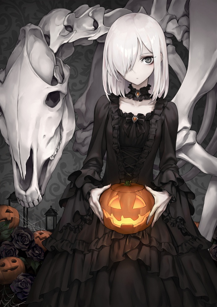 Girl in black dress holding a Halloween pumpkin