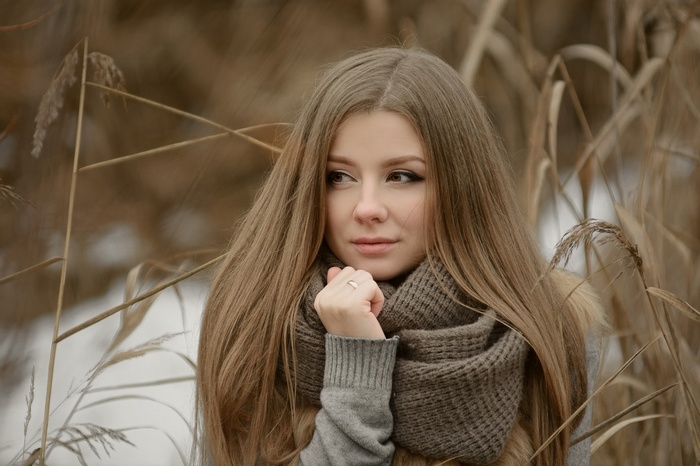 Woman with long brown hair wearing a scarf