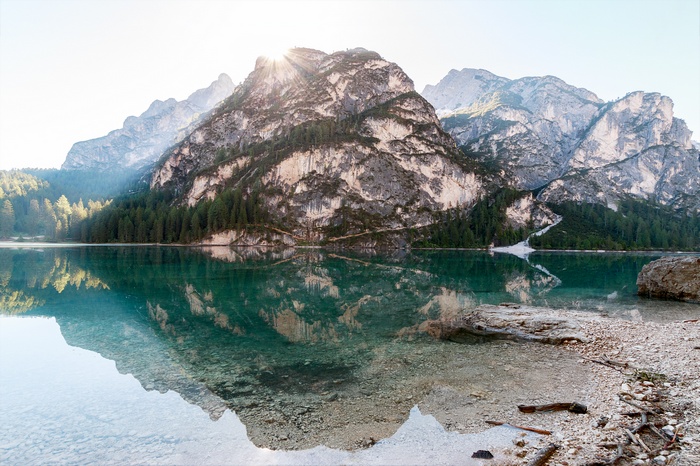 Mountain lake with reflection and rocky shore