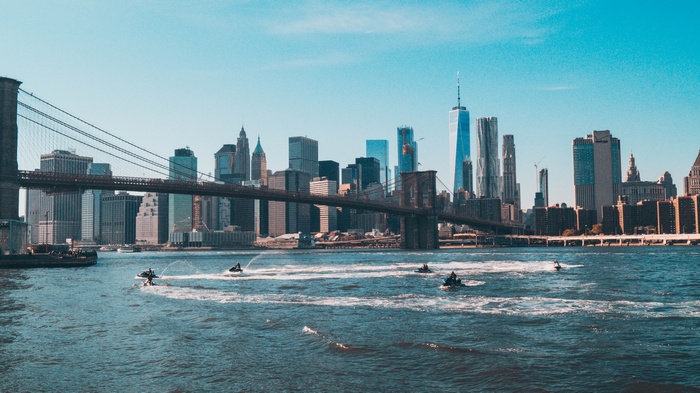 New York City cityscape with Brooklyn Bridge and jet skis