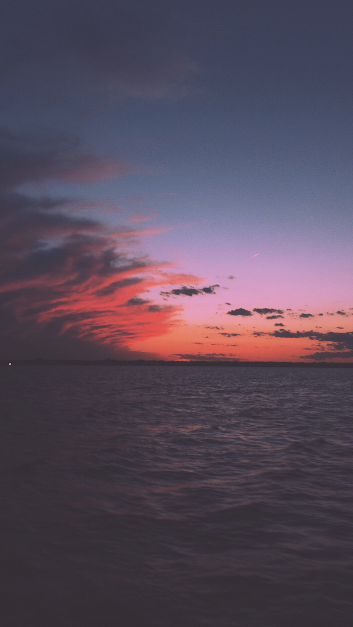Sunset over the sea with colorful clouds