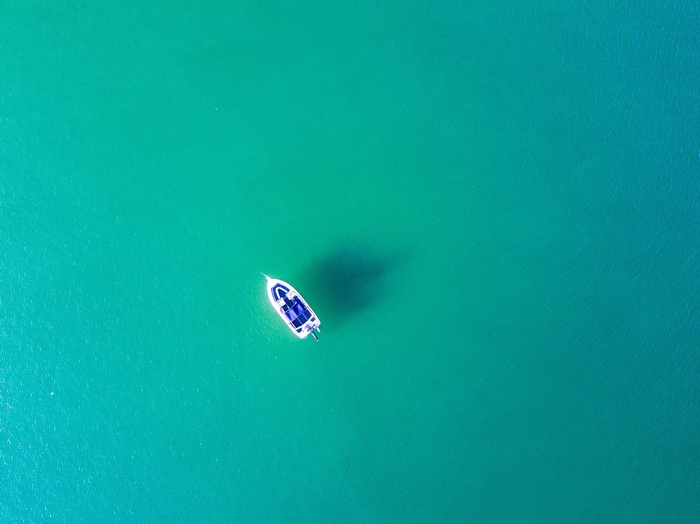 Aerial view of a white boat on turquoise water