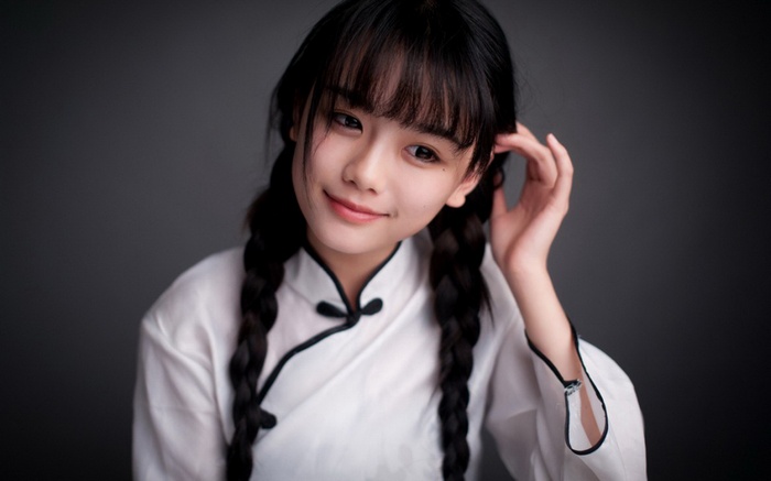 Young Asian woman in traditional Chinese dress with braided hair