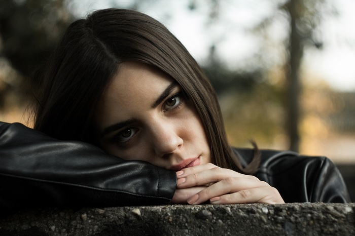 Woman in leather jacket looking at viewer