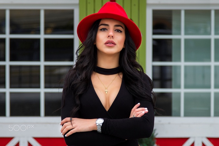 Woman in red hat and black top