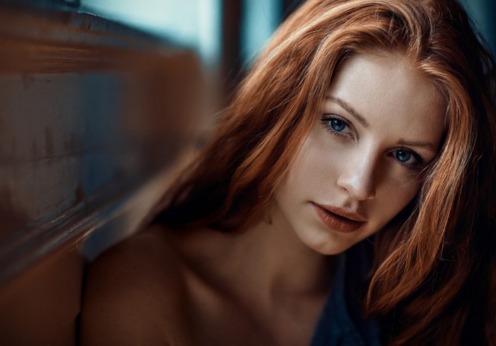 Redhead woman with blue eyes, close-up portrait